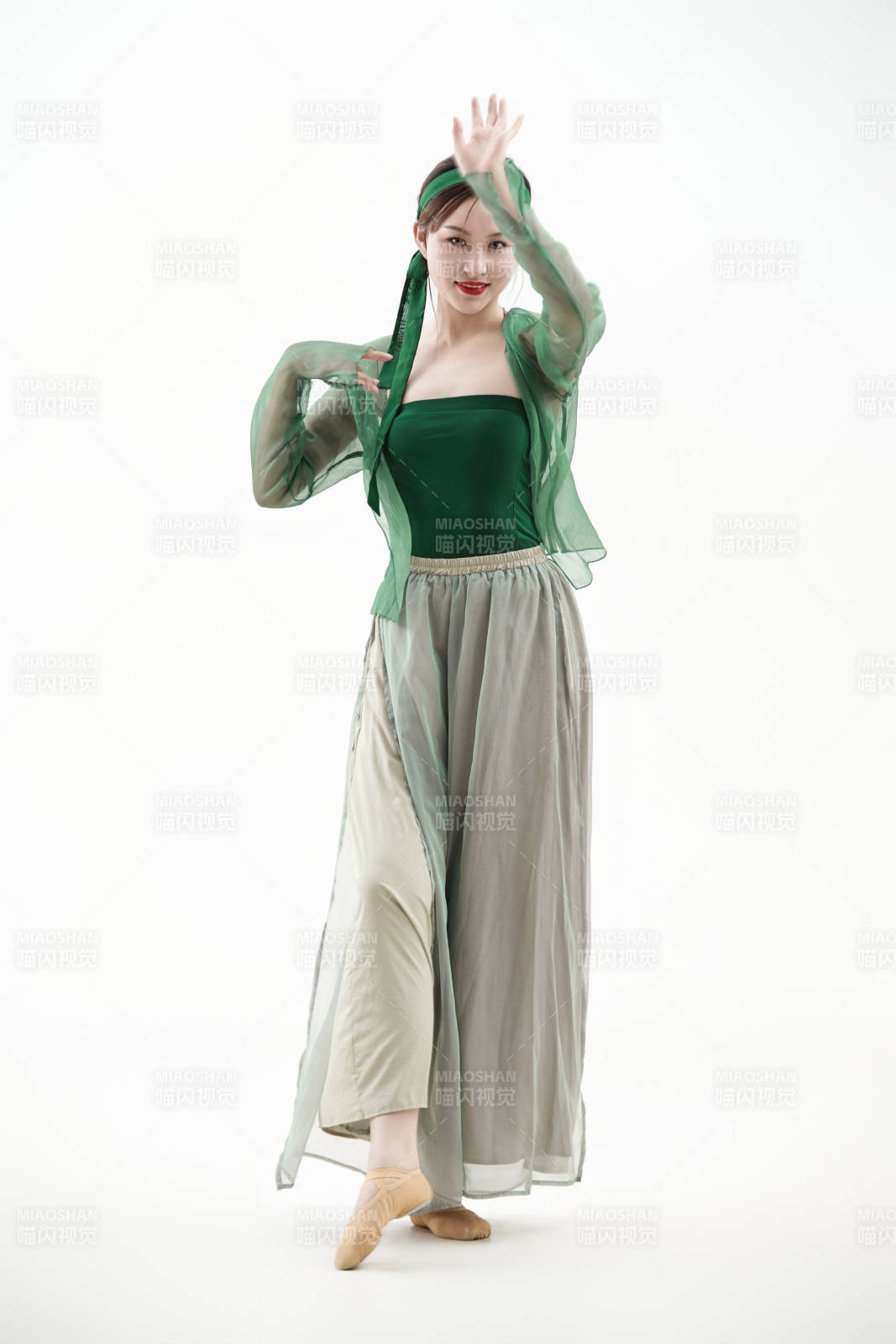 身穿青色古典舞蹈服裝手拿蒲扇跳舞的少女