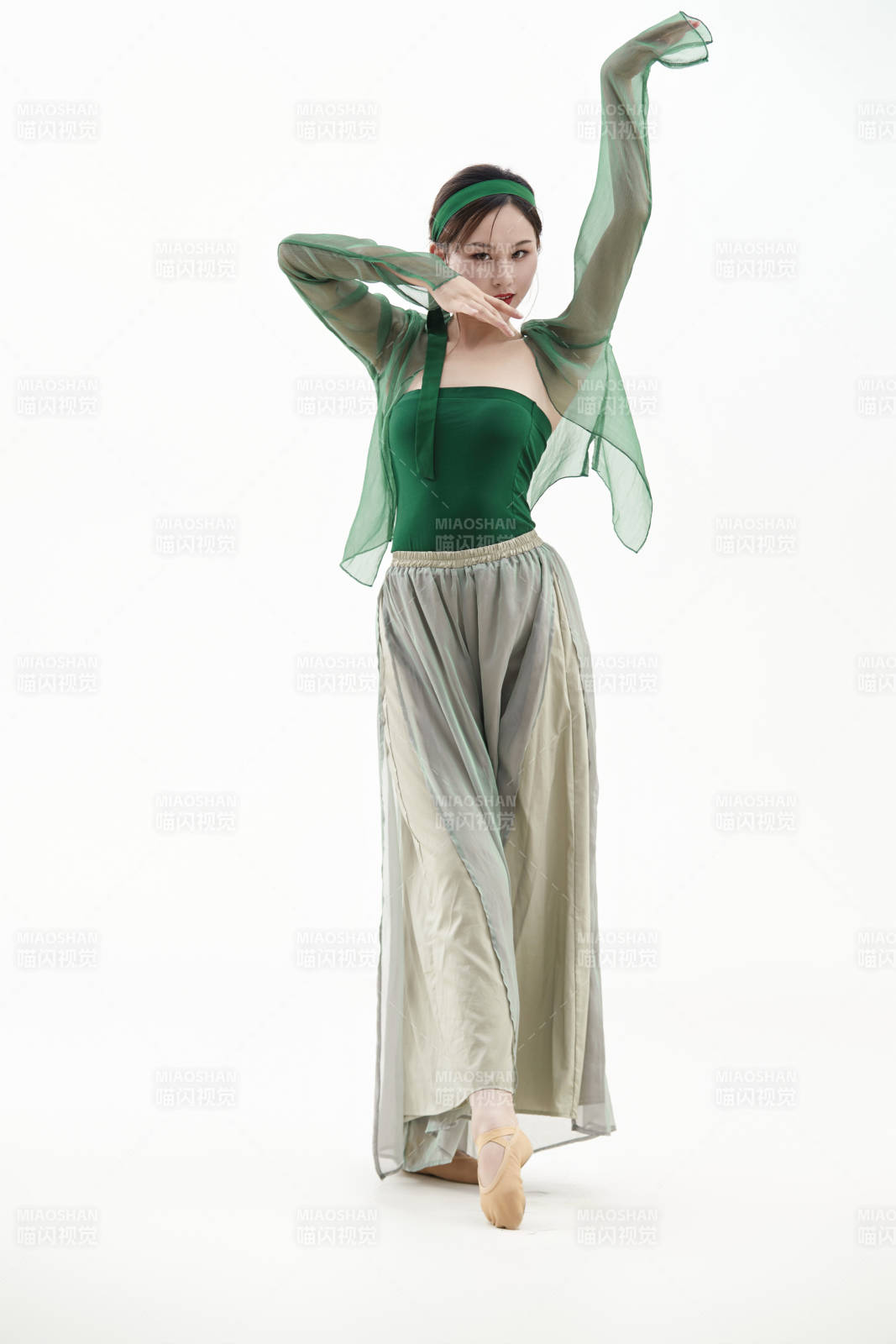 身穿青色古典舞蹈服裝手拿蒲扇跳舞的少女