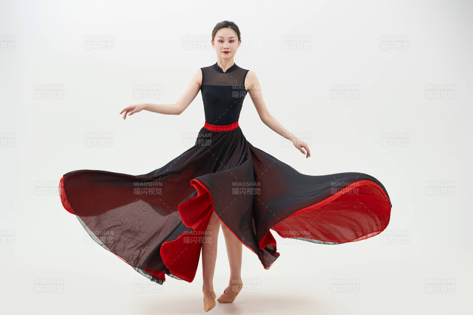 身穿紅黑相間的舞蹈長裙翩翩起舞的少女