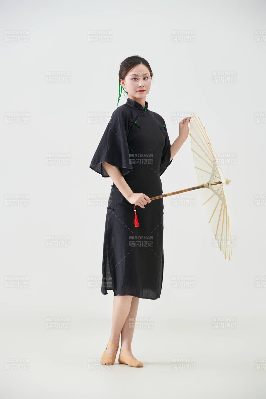 穿中式旗袍手拿油紙傘翩翩舞蹈的亞洲少女舞者