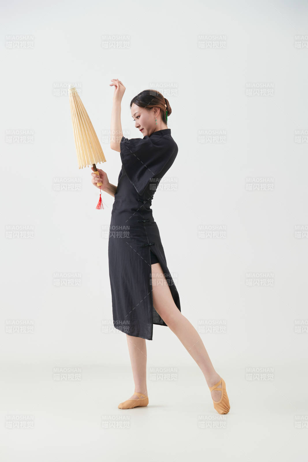 穿中式旗袍手拿油紙傘翩翩舞蹈的亞洲少女舞者