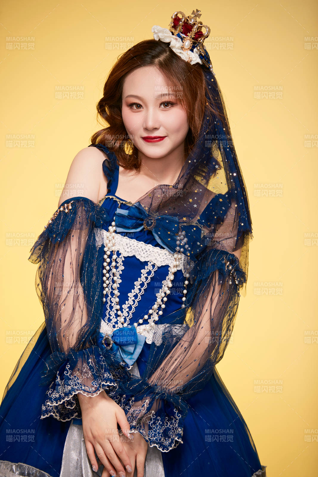 黄色背景下穿着欧式宫廷晚装庆祝生日的少女