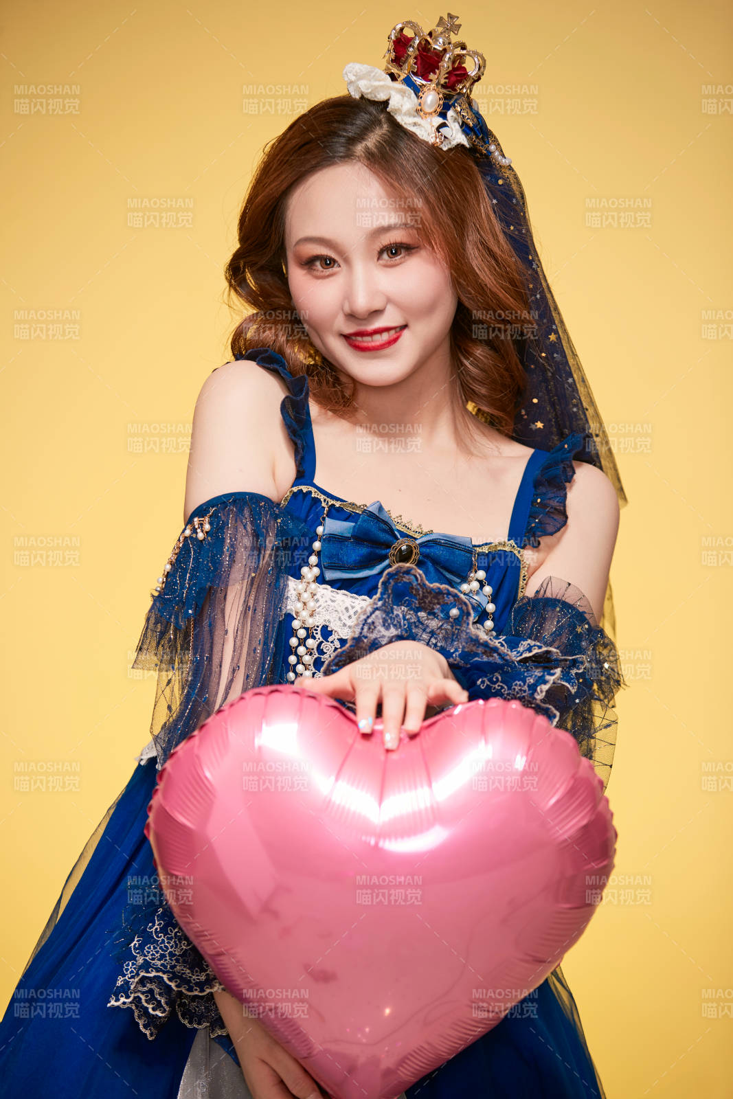 黃色背景下穿著歐式宮廷晚裝慶祝生日的少女