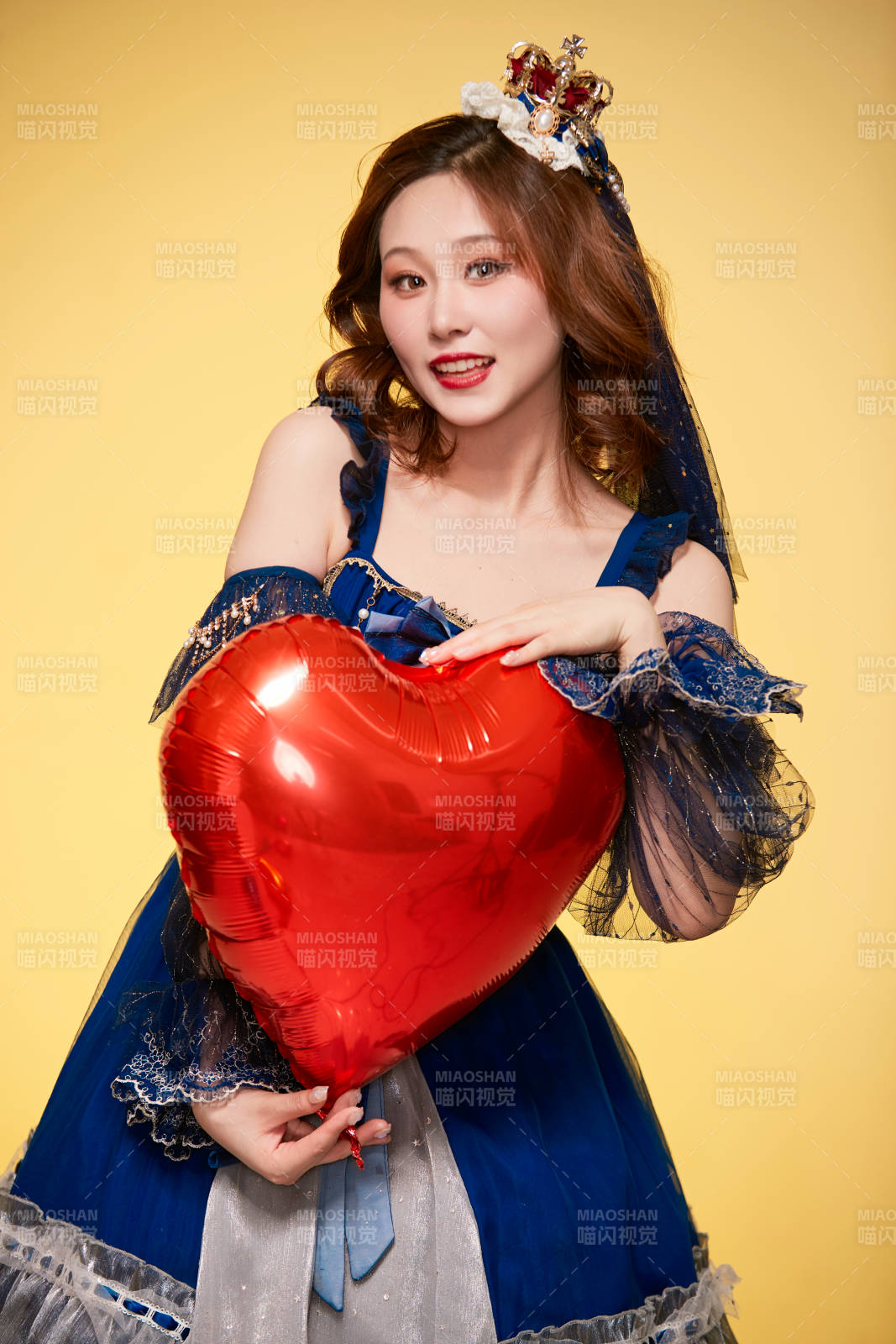 黄色背景下穿着欧式宫廷晚装庆祝生日的少女