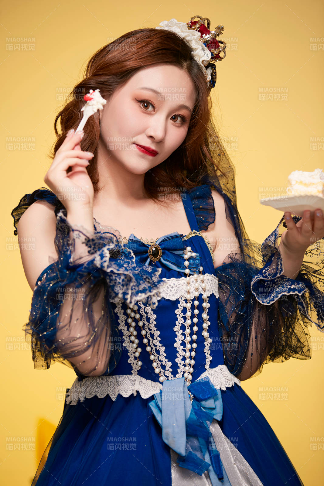 黃色背景下穿著歐式宮廷晚裝慶祝生日的少女