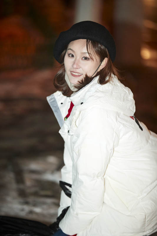 夜晚在繁华灯火的街头拍照的亚洲少女