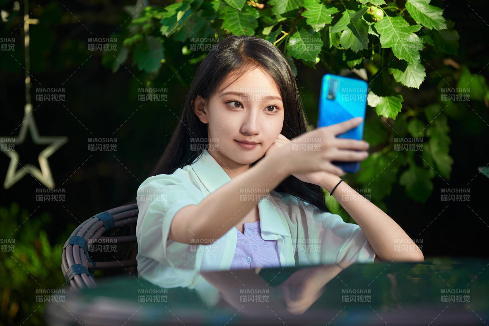 夕陽下在庭院休息拍照的亞洲少女