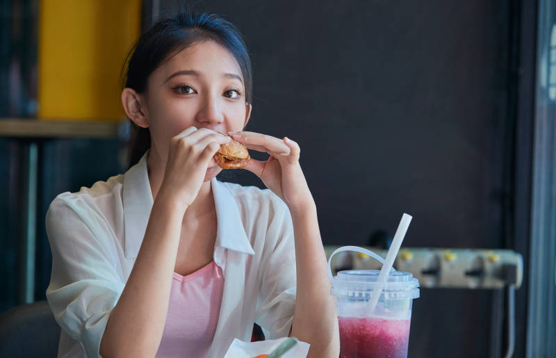 在商场快餐厅大吃特吃的中国可爱少女人像