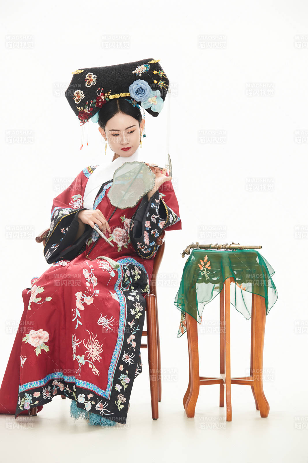 白色背景下穿着中国清朝宫廷服饰的少女