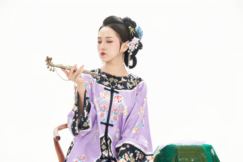 白色背景下穿著中國清朝晚清服飾的少女