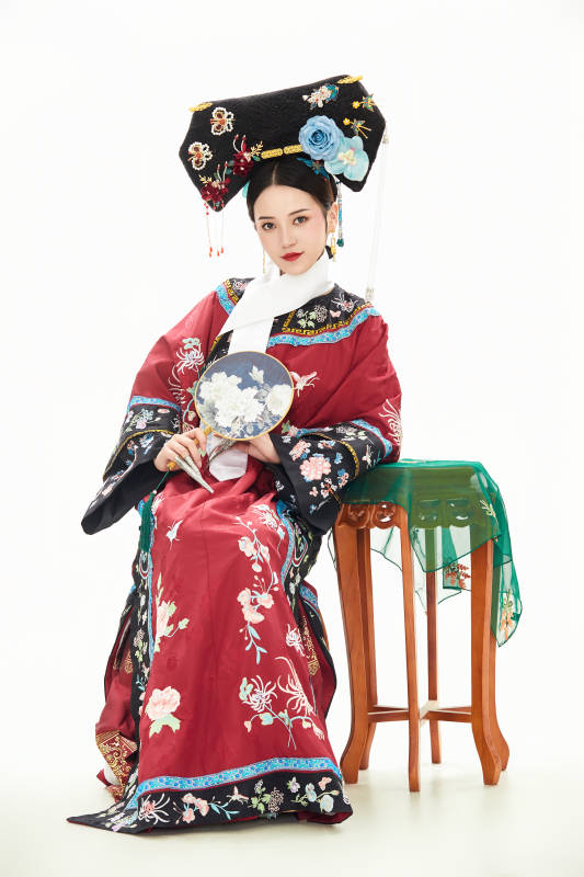 白色背景下穿着中国清朝宫廷服饰的少女
