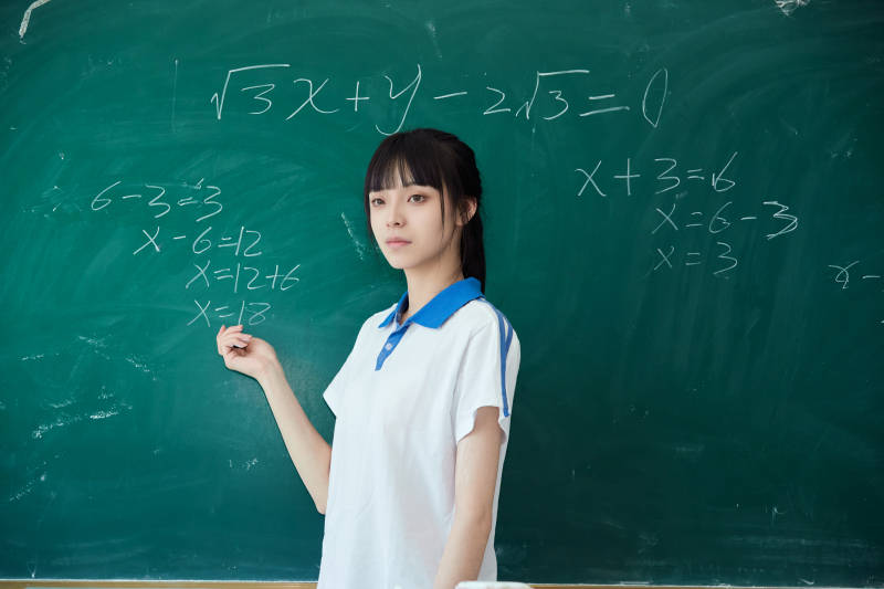 上课时在教室黑板解答数学习题的高中生