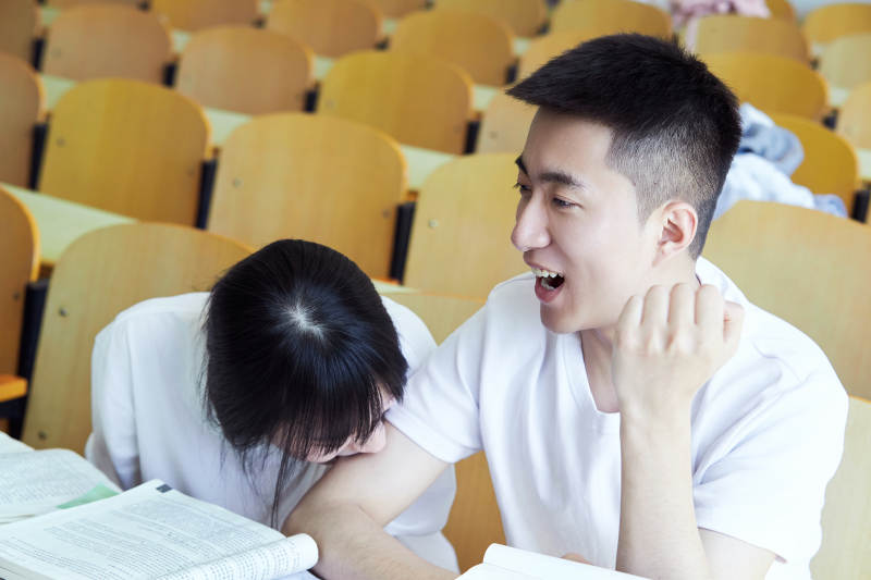 大学自习室相互依偎的青年情侣