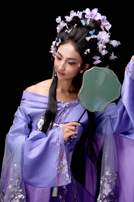 身著簪花仕女裝扮手持輕扇的東方女性