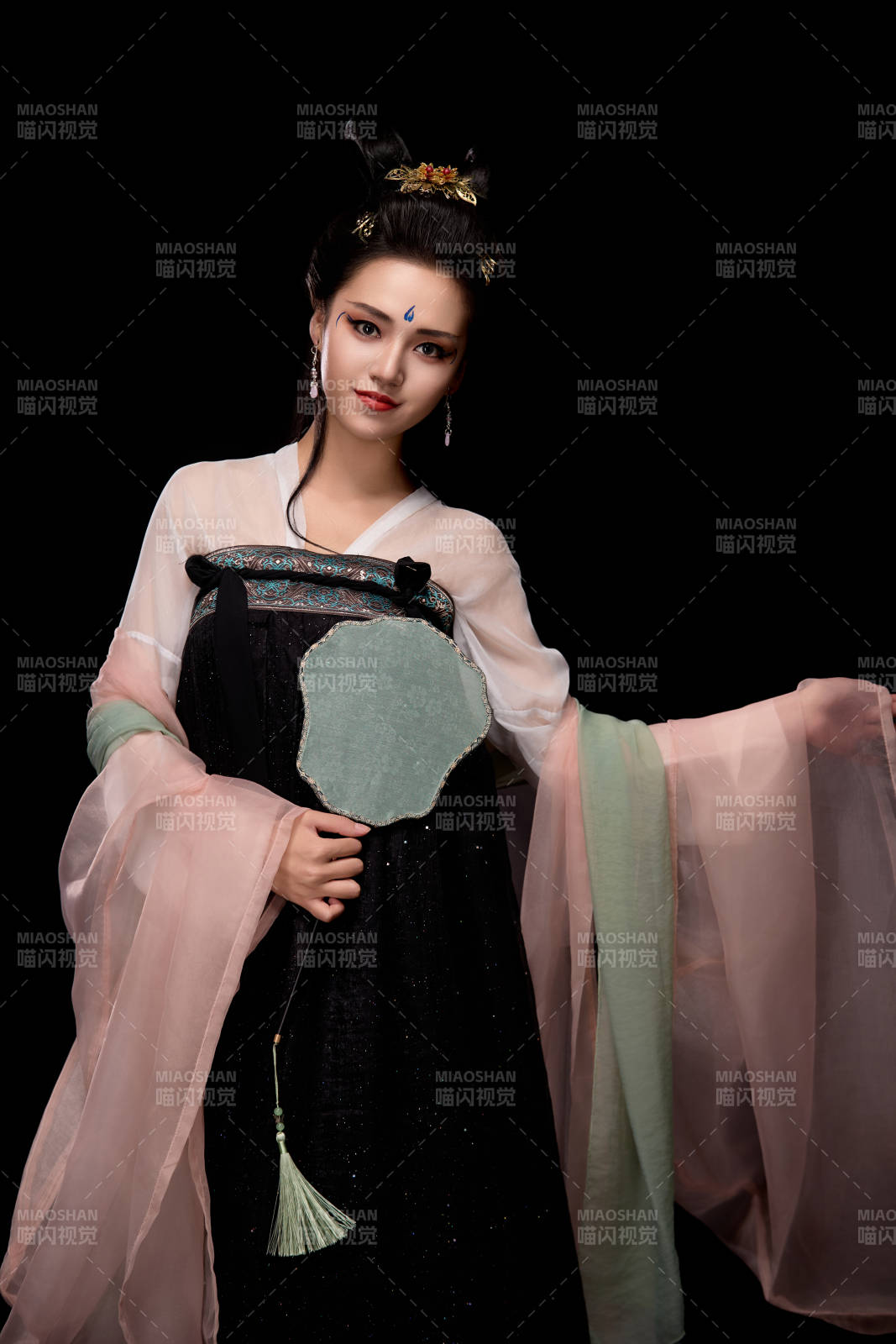 手持輕扇展示唐代服飾妝容造型的東方女性圖片