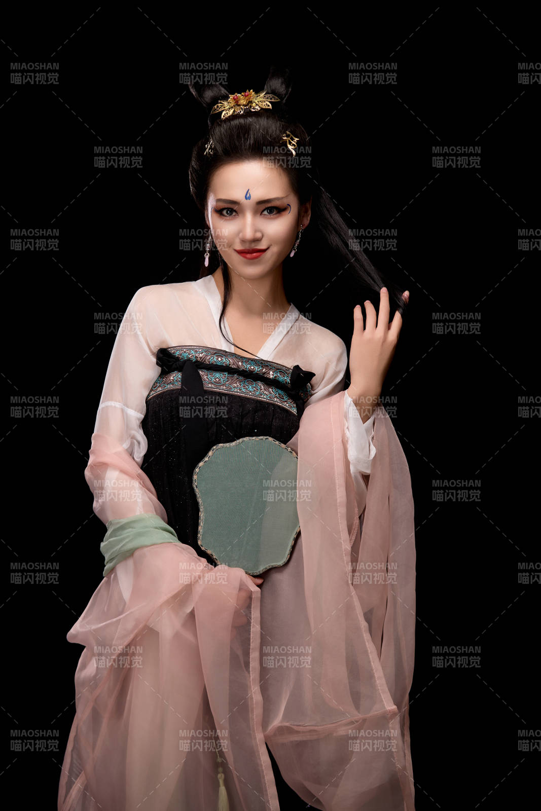 手持輕扇展示唐代服飾妝容造型的東方女性