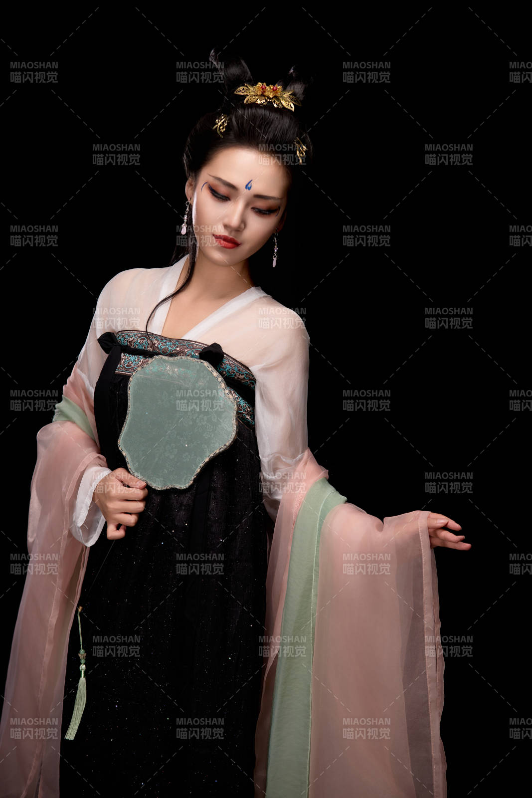 手持輕扇展示唐代服飾妝容造型的東方女性