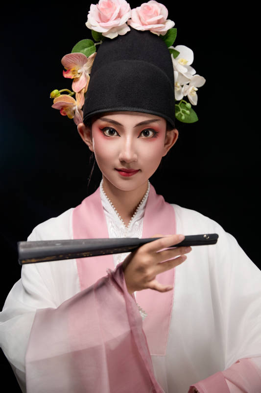 身着粤剧戏曲反串装扮手持折扇的青年女性