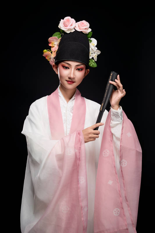 身着粤剧戏曲反串装扮手持折扇的青年女性
