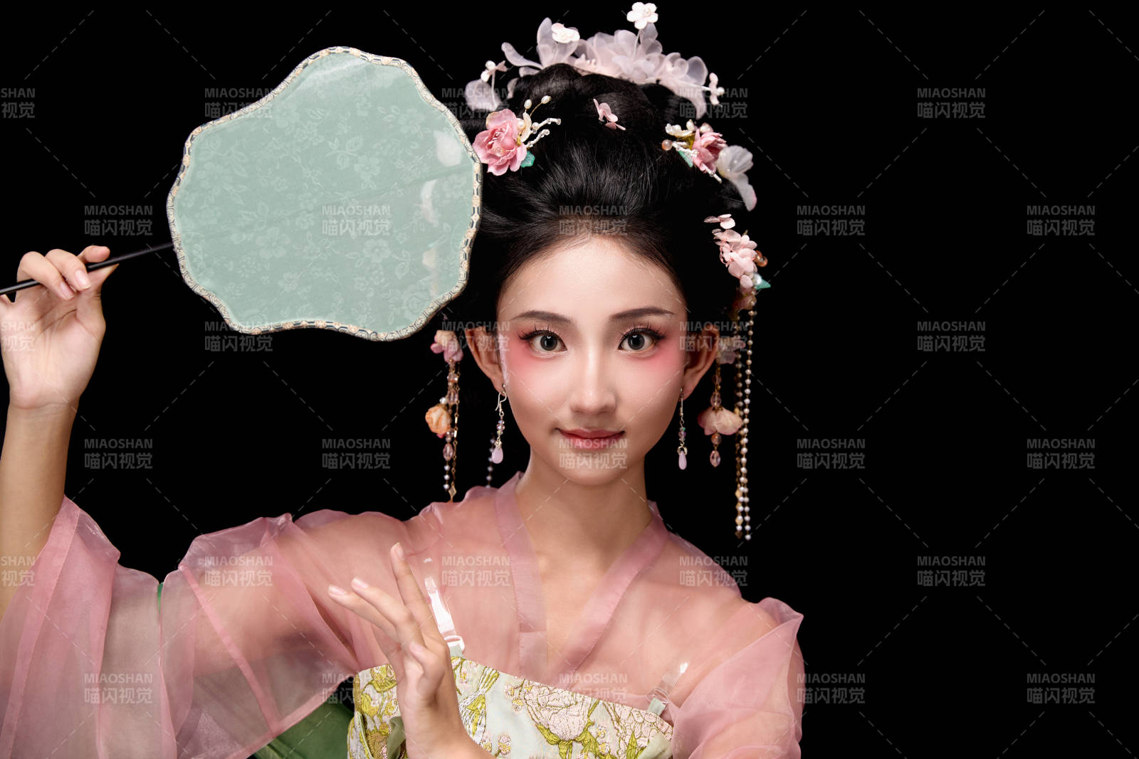 身著唐代宮廷簪花仕女服手持輕扇的女性