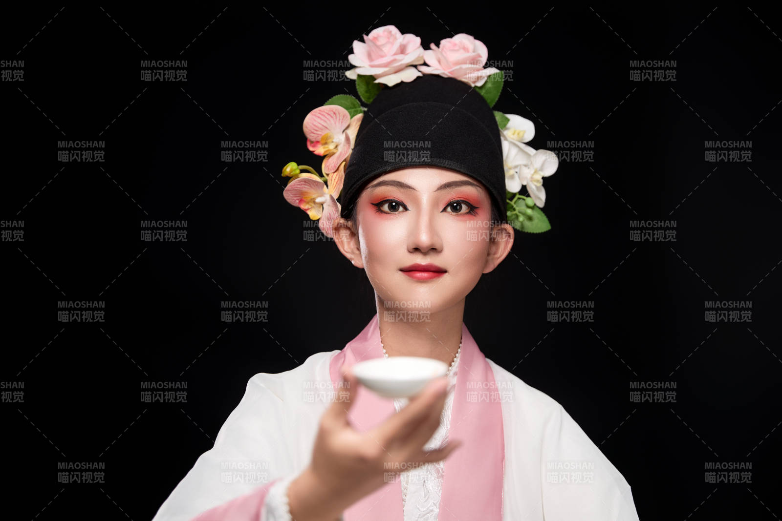 身著粵劇反串裝扮手持酒杯折扇的青年女性