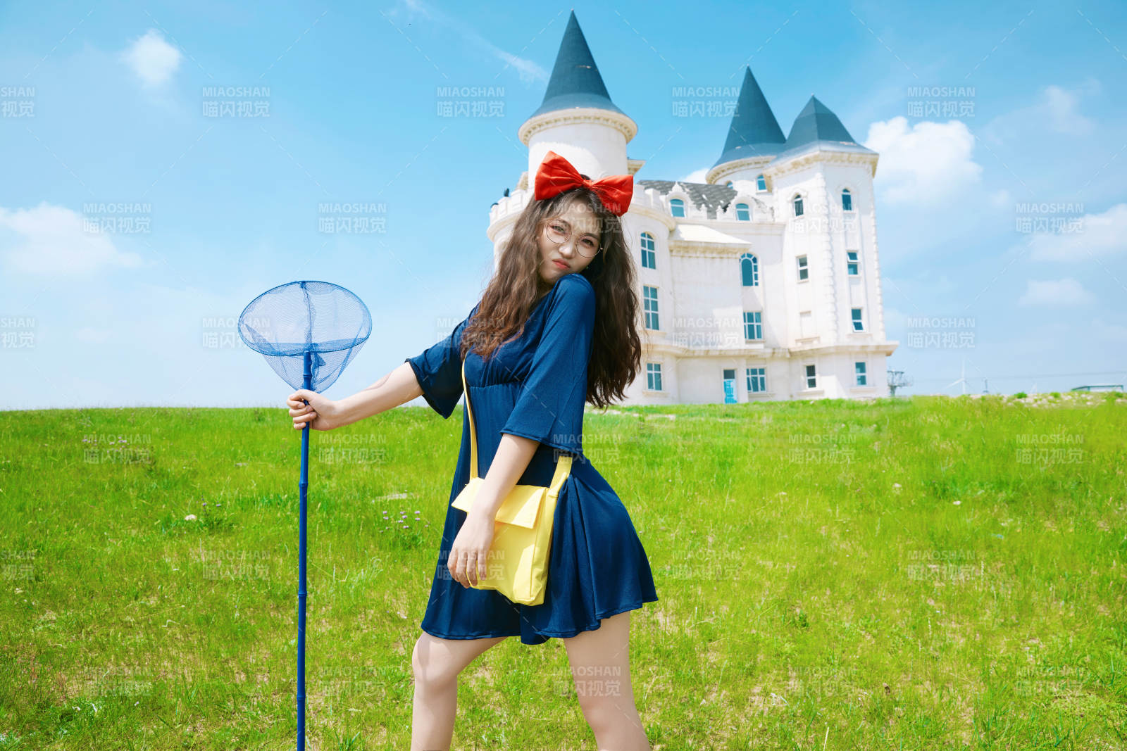 身穿小魔女服饰在城堡前拍照打卡的亚洲美女