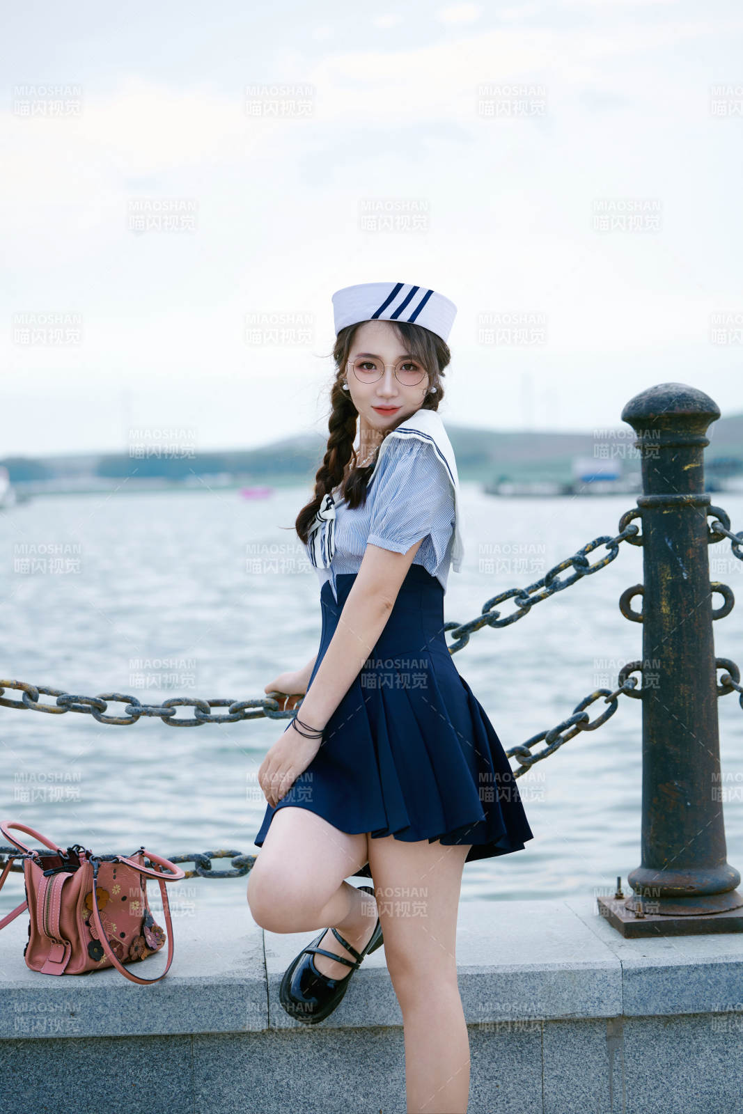 身穿水兵服在湖畔打卡拍照的亚洲美女