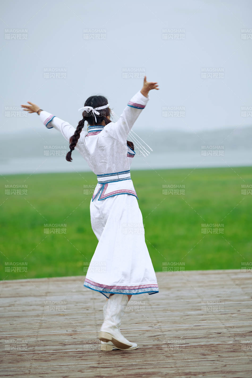 在草原穿著古風服飾拍照的亞洲美女