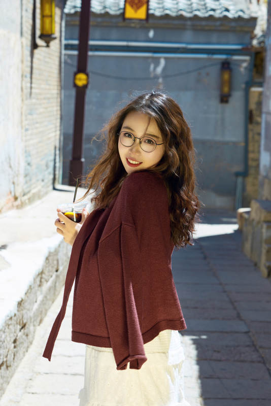 在老旧城区拍照游玩的东方美女