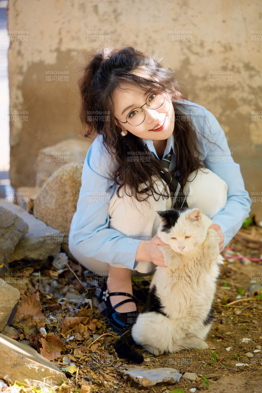 在小區里投喂流浪貓咪的東方女性