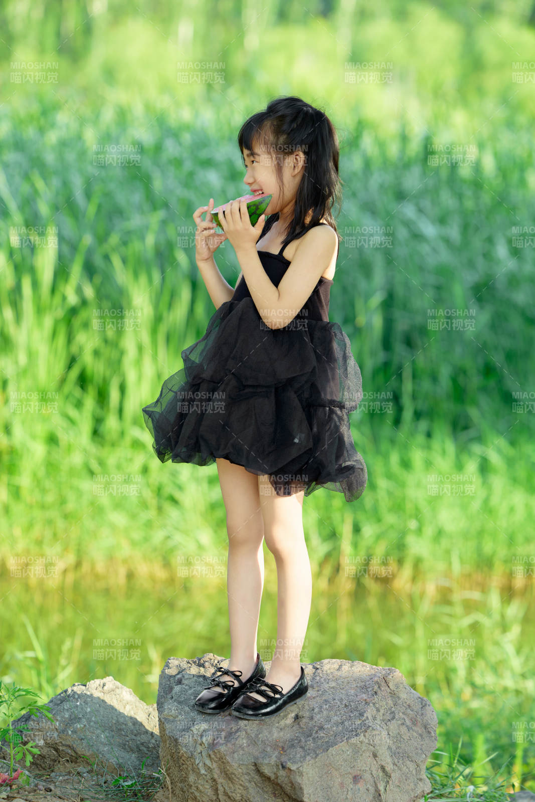 夏季在戶外游玩吃西瓜的可愛亞洲女童