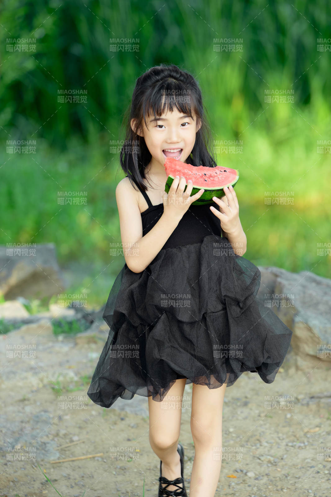 夏季在户外游玩吃西瓜的可爱亚洲女童