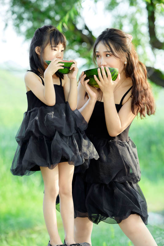 夏天在户外公园吃西瓜的亚洲母女亲子