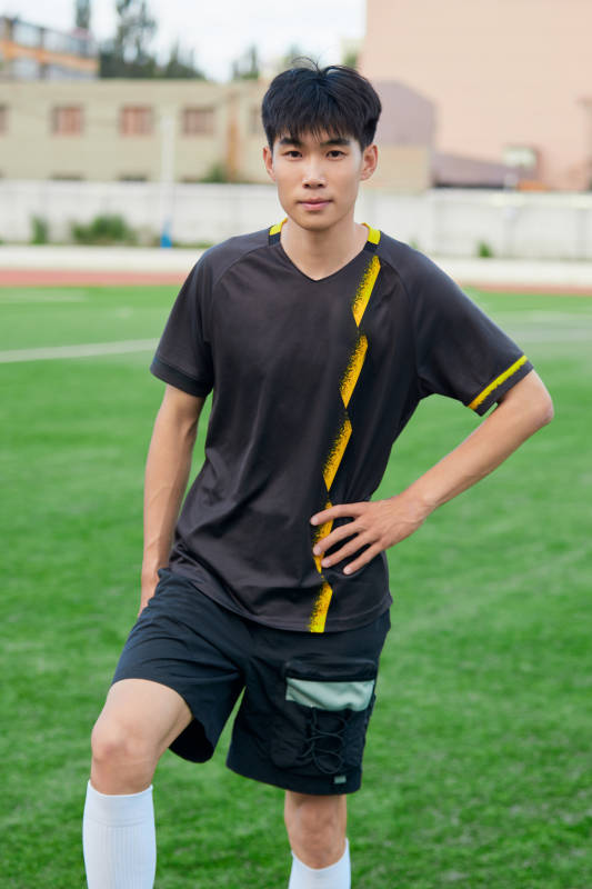 户外足球场上踢足球的运动员