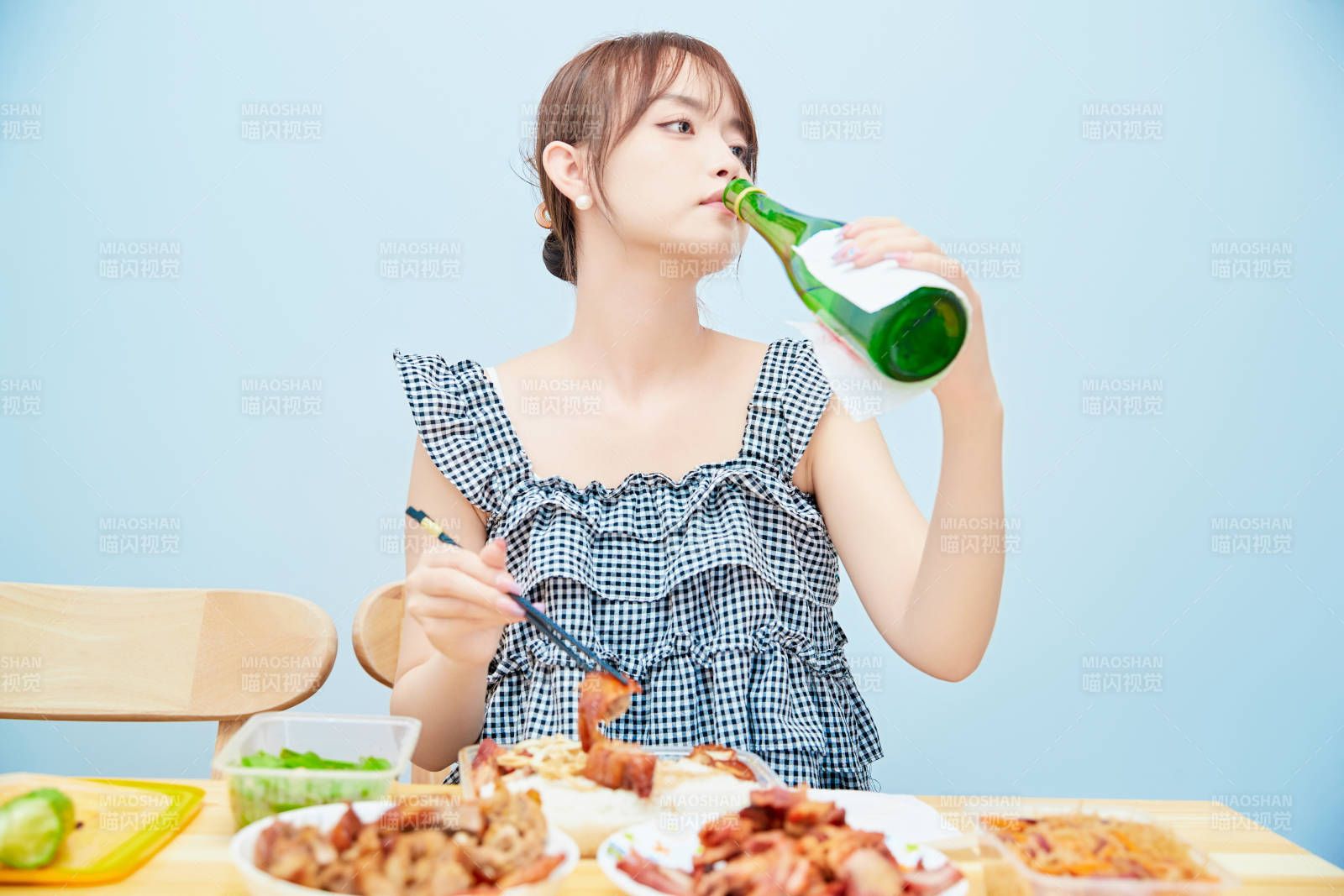 在餐桌前吃午餐喝白酒的亚洲少女