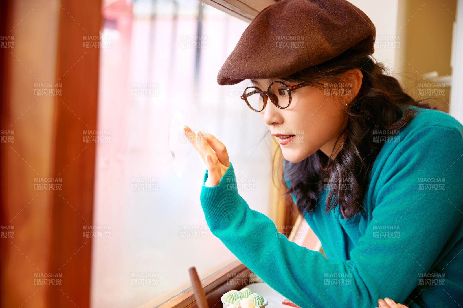 冬日午后坐在咖啡店吃蛋糕喝咖啡的亚洲美女