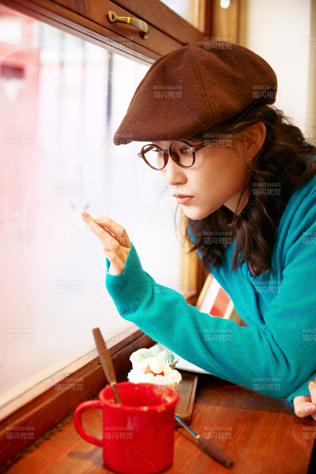 冬日午后坐在咖啡店吃蛋糕喝咖啡的亚洲美女