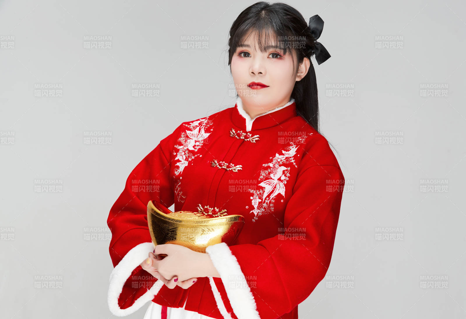 手捧金元寶身穿喜慶漢服的可愛少女