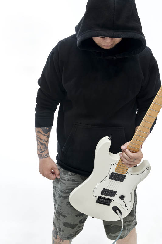 手持电吉他展示演奏的亚洲男性摇滚乐手人像