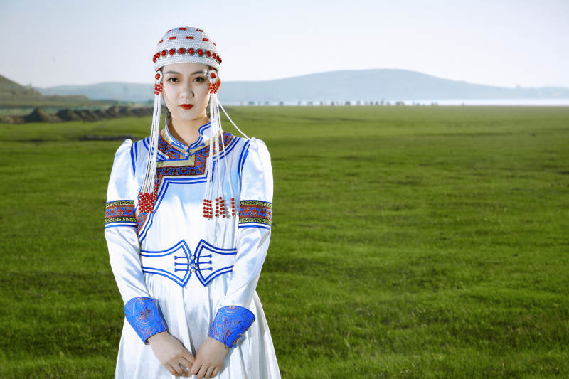 草原上穿着蒙古族传统服饰的亚洲年轻美少女