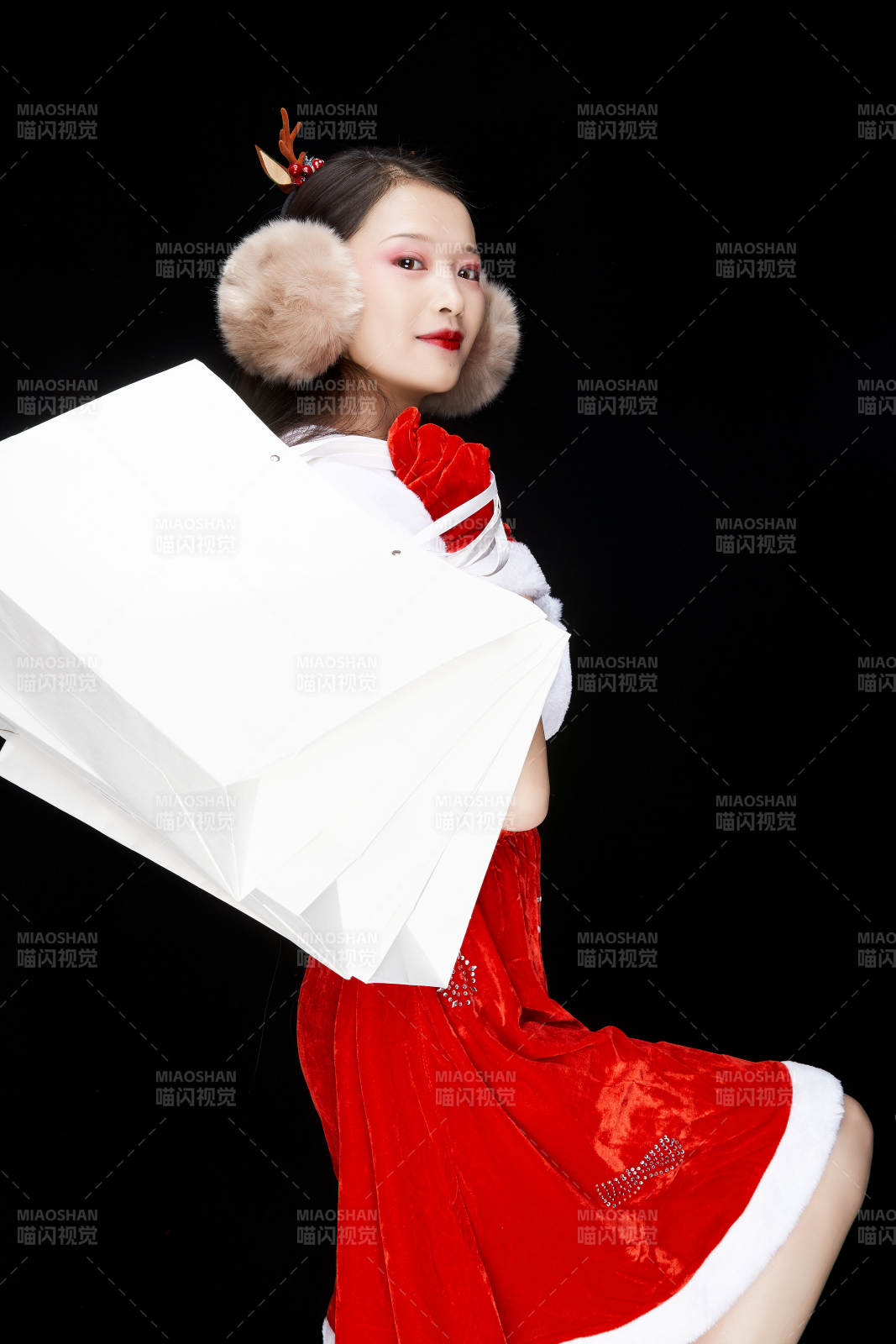 身穿圣誕服飾手提購物袋性感可愛的圣誕女郎