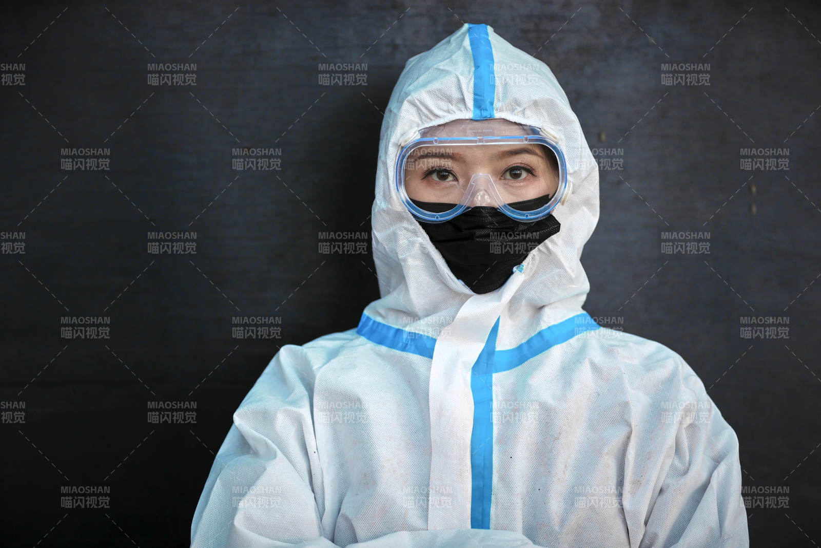 穿白色防護服佩戴護目鏡口罩的女性防護人員