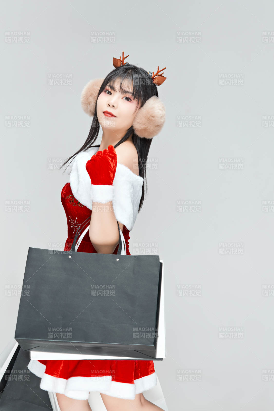 身穿圣誕服飾手提購物袋性感可愛的圣誕女郎