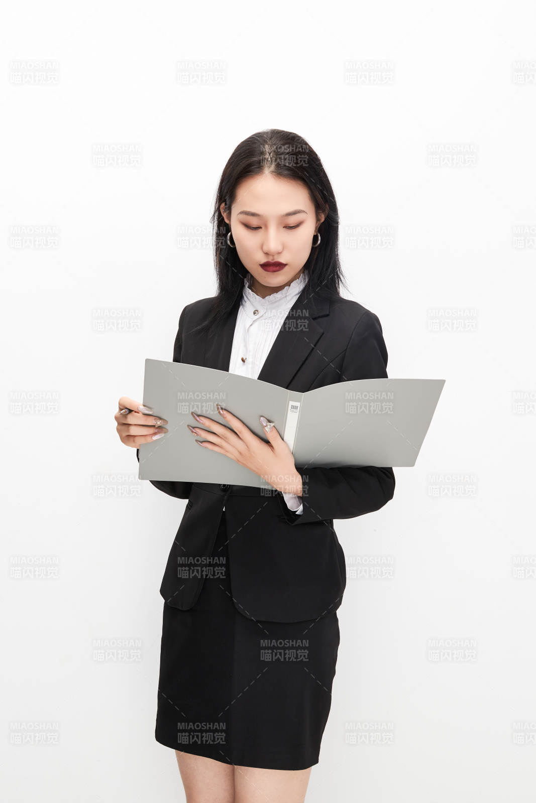 身穿西服拿著文件夾的美麗商務女士