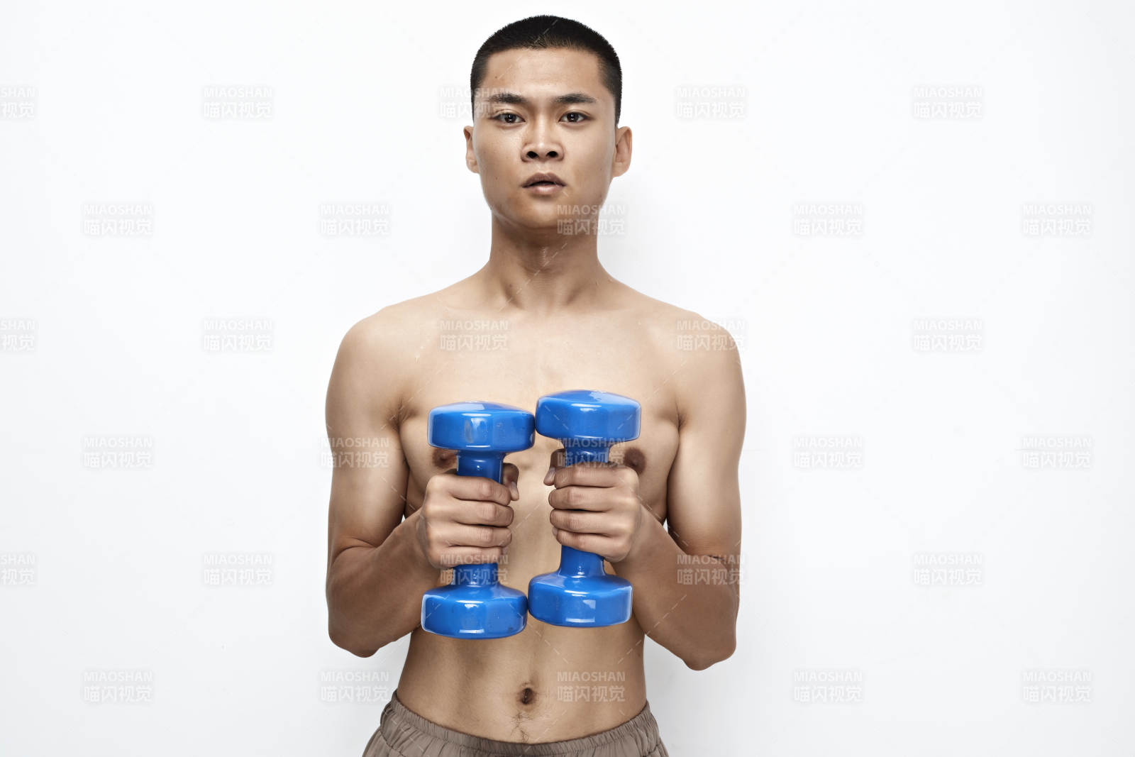 使用啞鈴進(jìn)行健身鍛煉的亞洲男性