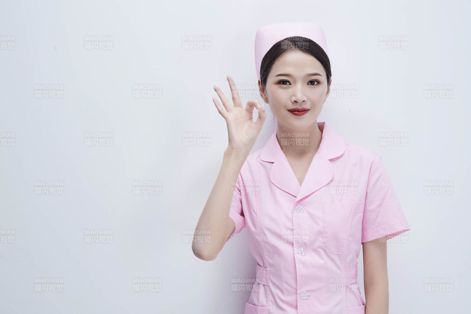 身穿粉色護(hù)士服佩戴聽診器的女性醫(yī)護(hù)人員