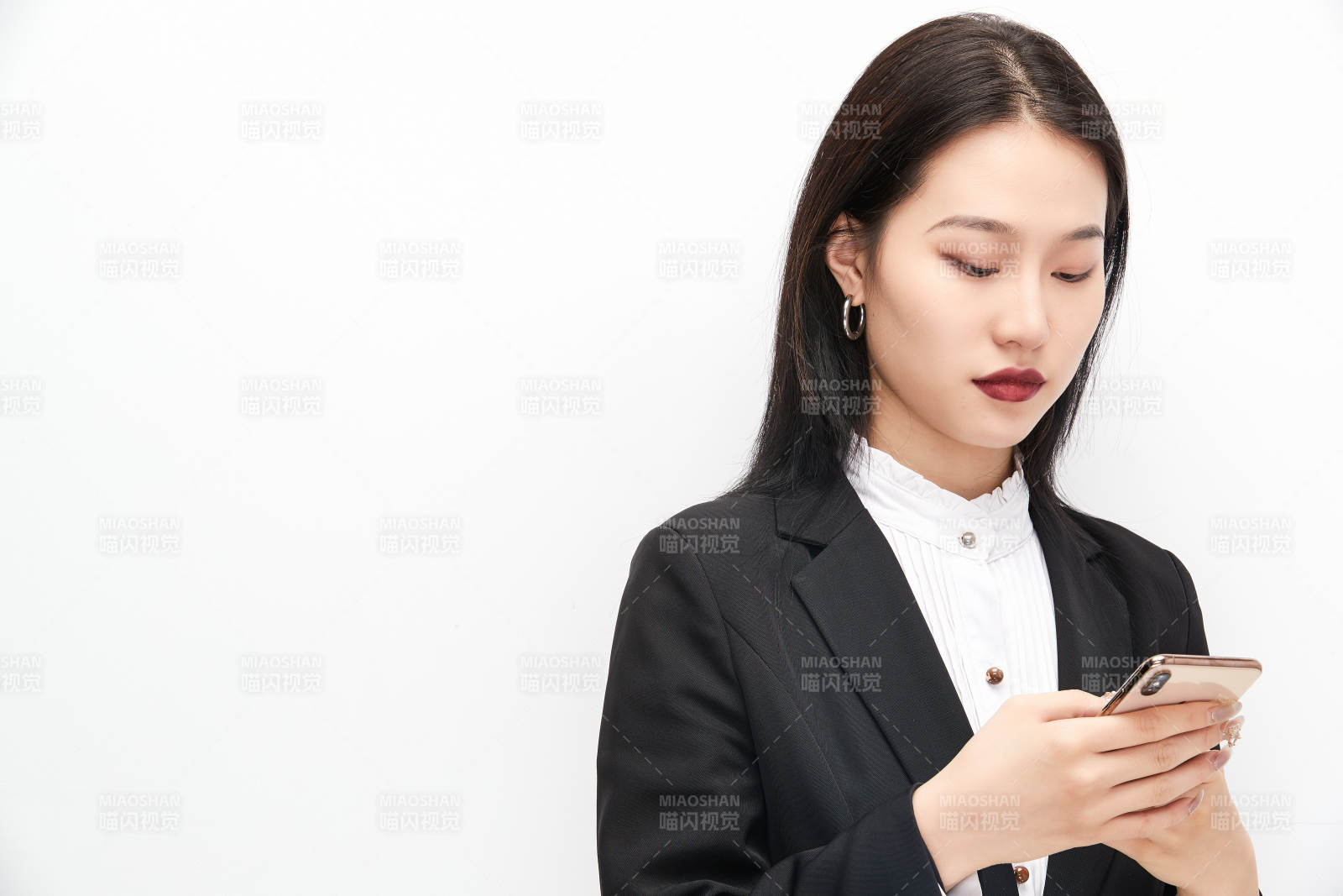 身穿西服拿著手機的美麗商務女士