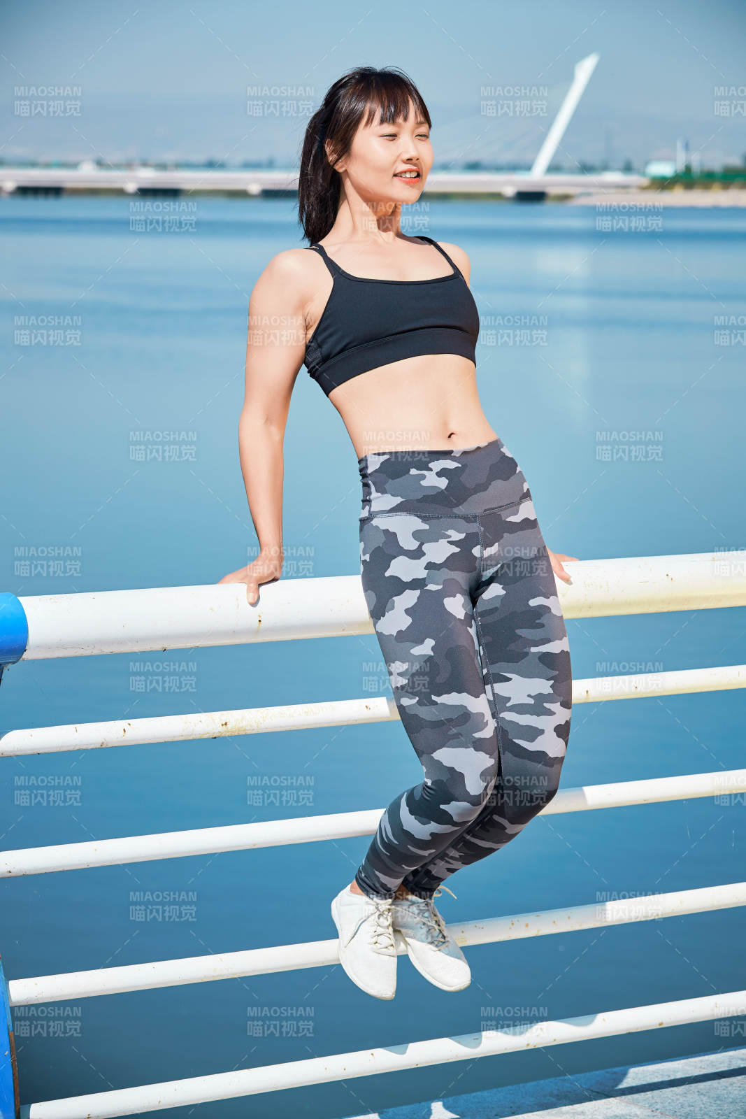 戶外河畔公園做拉伸有氧運(yùn)動(dòng)的亞洲女性