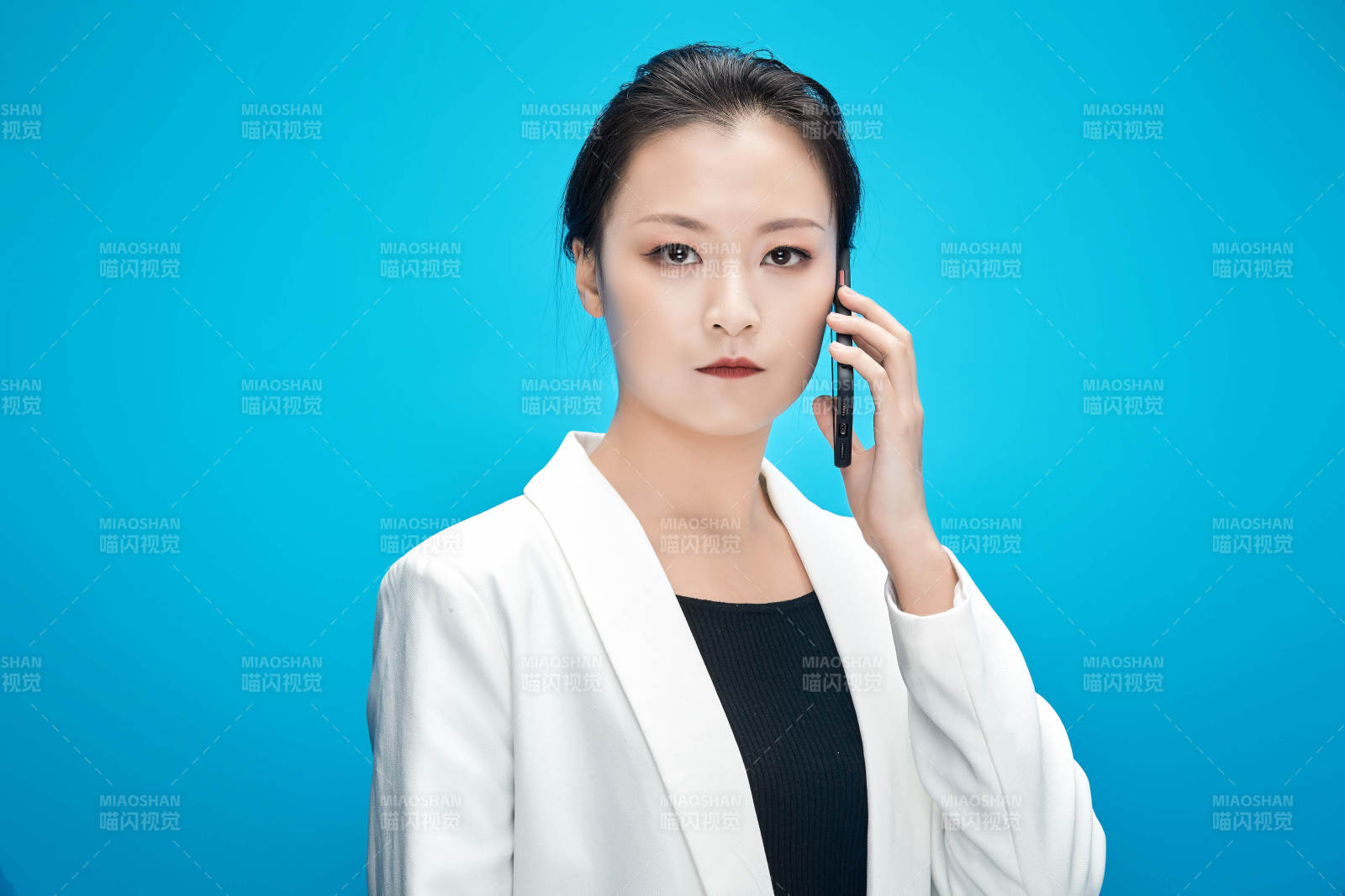 身穿西服拿著手機與文件夾的亞洲商務女士