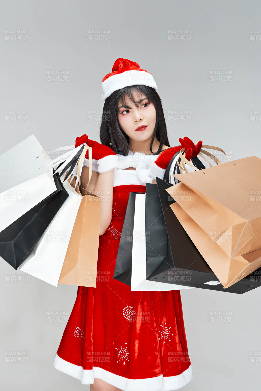 身穿圣誕服飾手提購物袋性感可愛的圣誕女郎